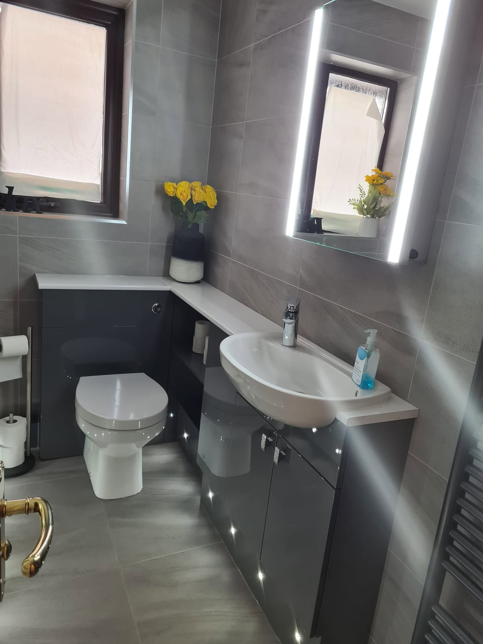 Bathroom with backlit mirror and plinth lighting