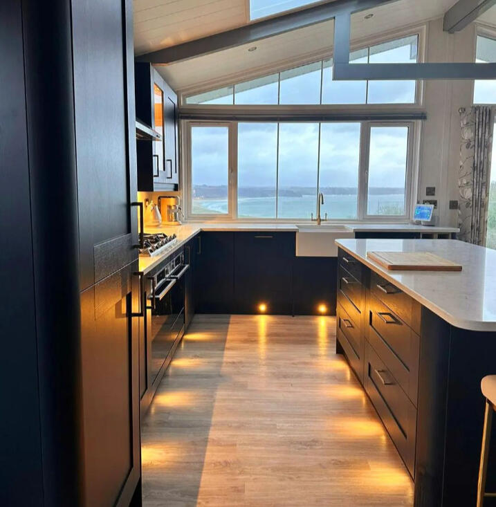 Dark kitchen with plinth lighting
